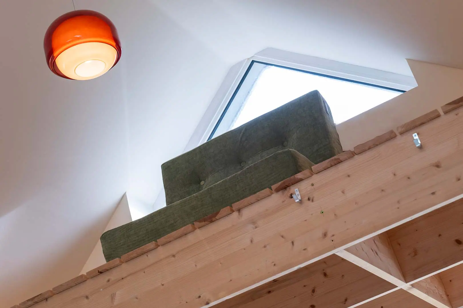 A mezzanine and roof light carry the height of the original house into the extension.