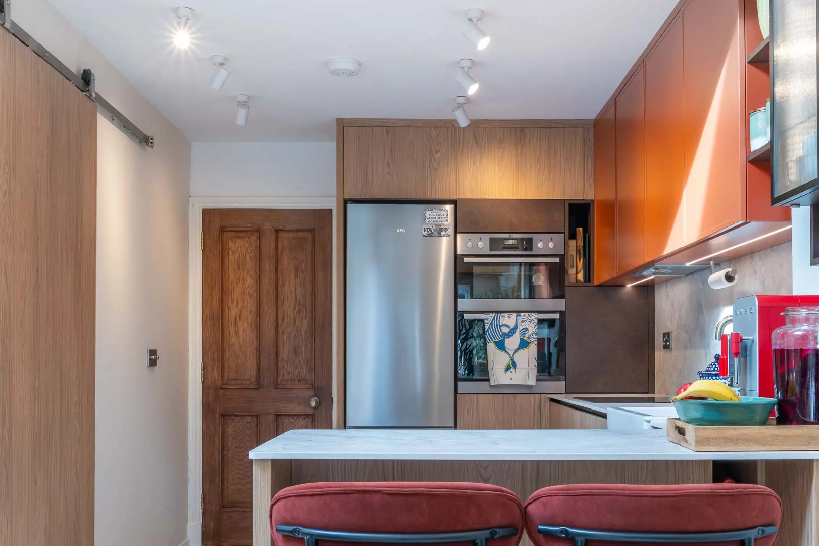 The kitchen holds the join between the original house and the new work.
