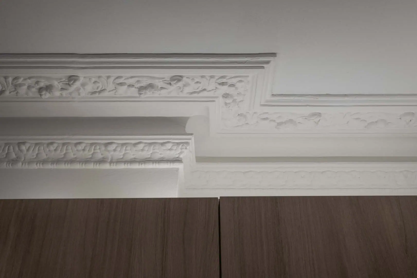 Original cornice left intact where the new joinery meets the ceiling.