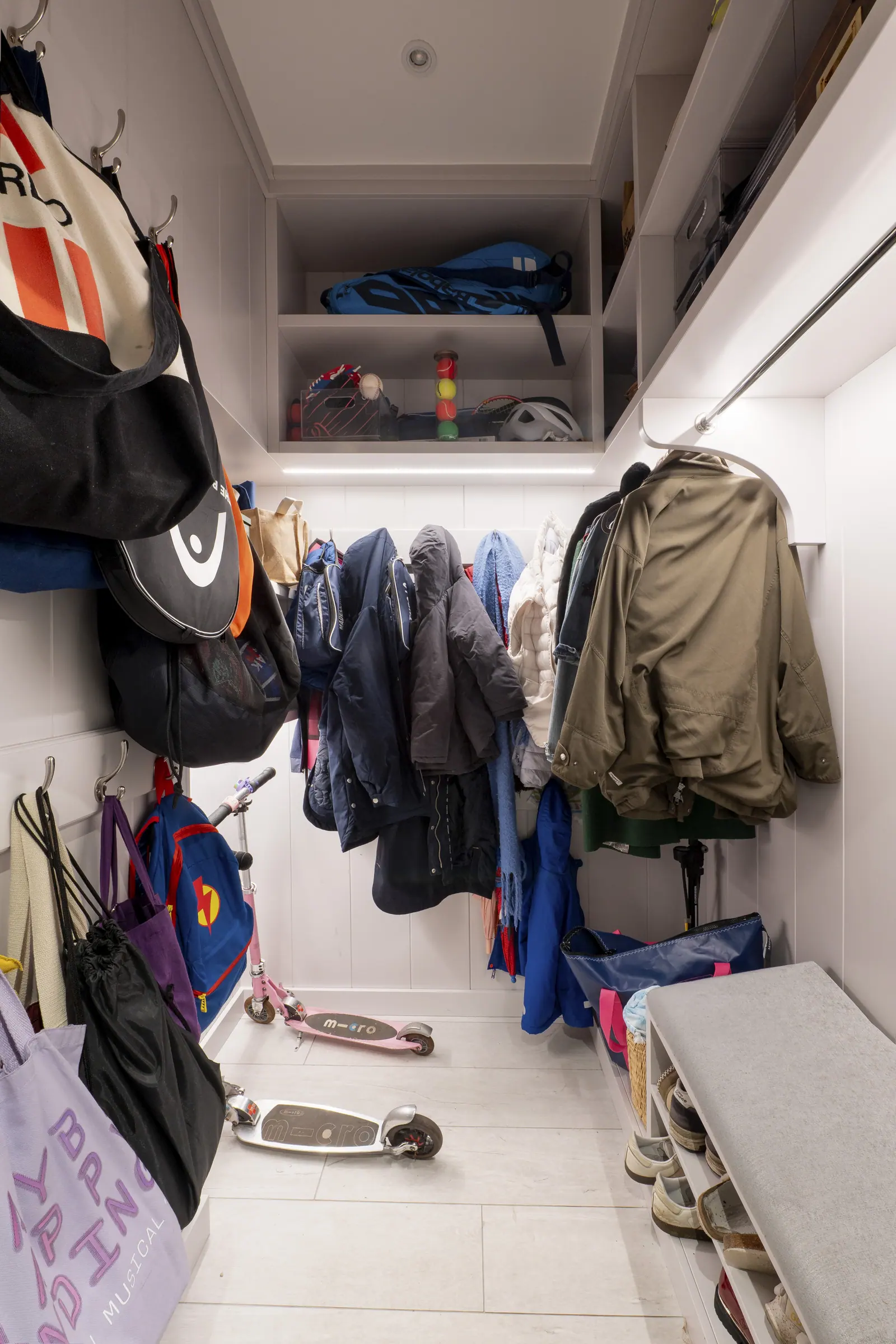 A boot room off the hall takes coats, shoes and school bags.